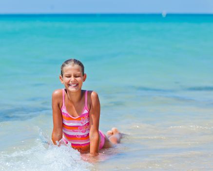 Summer vacation - Happy cute girl having fun with surfboard in the ocean