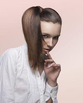 attractive girl with long brown smooth hair in ponytail on the right side of the face, wearing white shirt