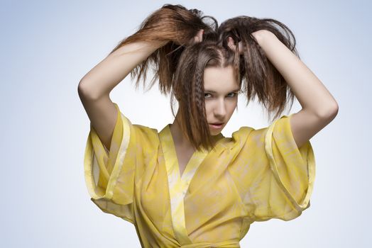 glamour portrait of young brunette girl with long hair wearing sexy transparent nightgown and playing with her hair