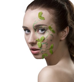 close-up portrait of pretty girl with nacked shoulders, creative fresh summer make-up with mint leaves