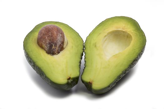 avocado halves with bone on white background