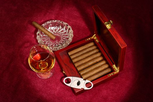 cigars in the box and glass with whisky, close up shallow dof 