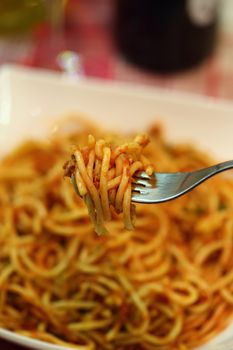 spaghetti a la putaneska and fork, close up
