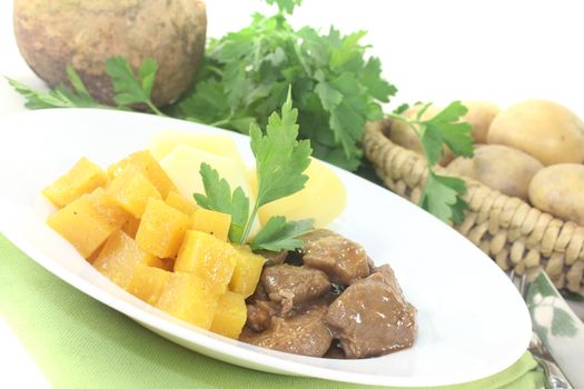 Venison goulash with turnip on a light background