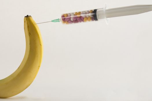 Male impotence metaphor: banana and syringe with pills