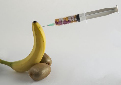 Male impotence metaphor: banana and syringe with pills