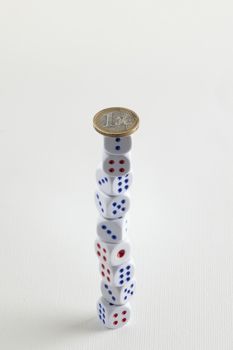 euro coin on dice stack