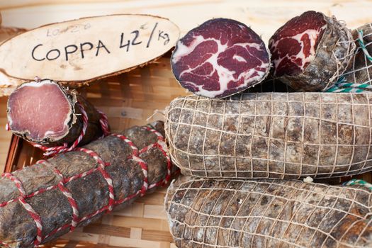 Rural hand-made sausage Coppa, gourmet meat product on Provence market