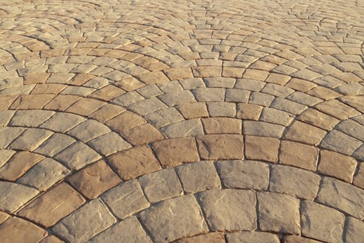 Beautiful brown stone walkway in arching pattern and design. 