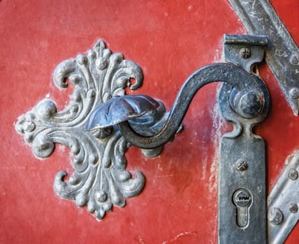 Door-handle decoration detail of old metal iron entrance door in Prague
