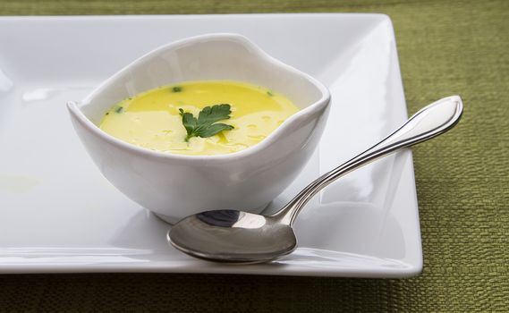 Bowl of chicken soup with chrome spoon
