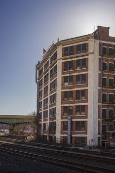 Train track passing behing a commercial building