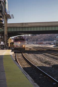 Train from the Boston suburbs coming into a station