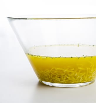 glass bowl filled with chicken noodle soup