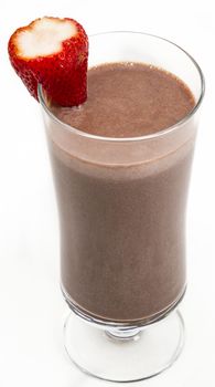 Chocolate milkshake with a strawberry on the side against a white background