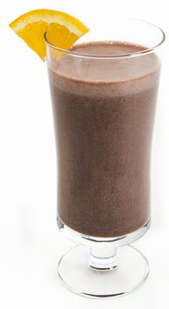 Chocolate milkshake with a slice of orange on the side against a white background