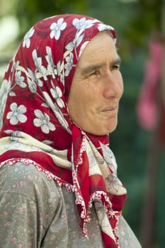 Alanya, Turkey-September 20th 2011: A Turkish woman vendor on the market wearing a traditional headscarf.  The wearing of headscarves by women in public institutions was banned until October 2013.