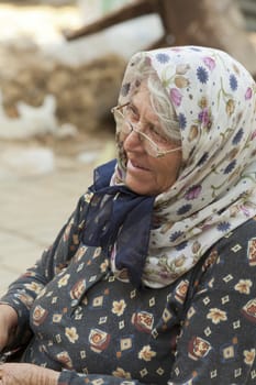 Alanya, Turkey-September 20th 2011: A Turkish woman vendor on the market wearing a headscarf.  The wearing of headscarves by women in public institutions was banned until October 2013.