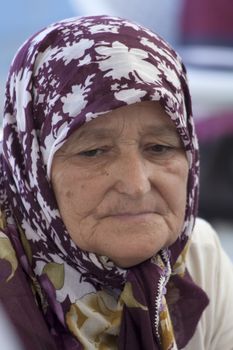 Alanya, Turkey-September 20th 2011: A Turkish woman shopping on the market wearing a traditional headscarf.  The wearing of headscarves by women in public institutions was banned until October 2013.