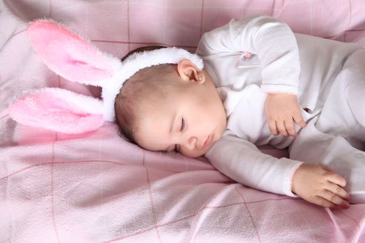 Sleeping easter bunny baby wearing fluffy ears