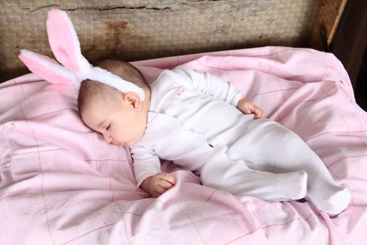 Sleeping easter bunny baby wearing fluffy ears