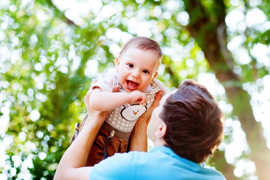 laughing boy in fathers hands