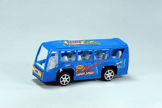 model of blue minibus on white scene,shallow focus