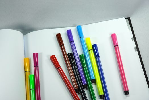 colourful magic pens and drawing book,shallow focus