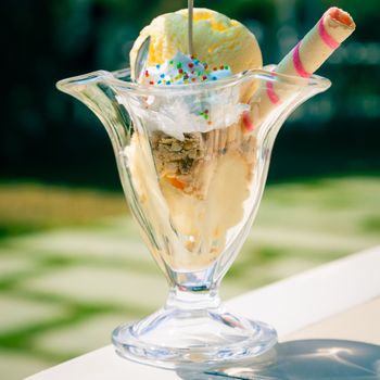 Caramel ice cream in cup outdoors