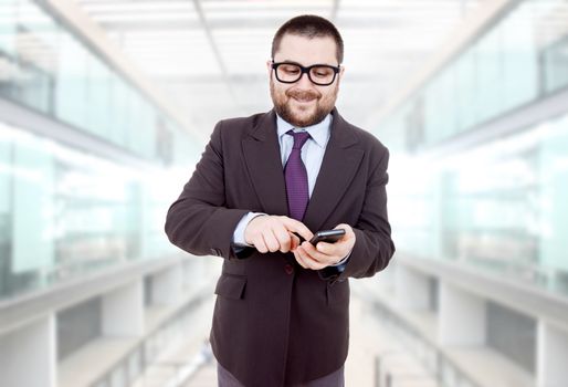 young silly business man using his phone at the office