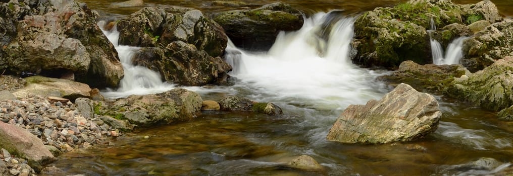 Cascade on some stream with mossy stones, horizontal