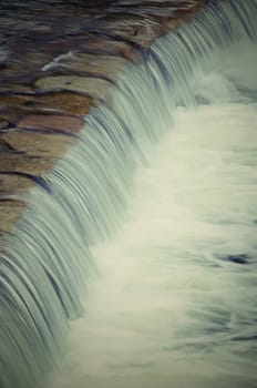 Some fast flow weir on the river, vertical