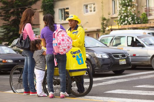 LIMA, PERU - MARCH 16, 2012: Unidentified people selling and buying D'Onofrio ice cream on the street on Malecon de la Reserva at Larcomar on March 16, 2012 in Miraflores, Lima, Peru. In summer, many street vendors sell ice cream on the streets in these bike-carts.