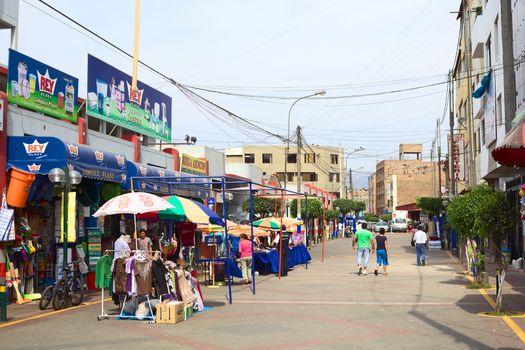 LIMA, PERU - FEBRUARY 13, 2012: Unidentified people on the street Narciso de la Colina with some household supply stores at the market called Mercado No. 1 de Surquillo on February 13, 2012 in Lima, Peru.