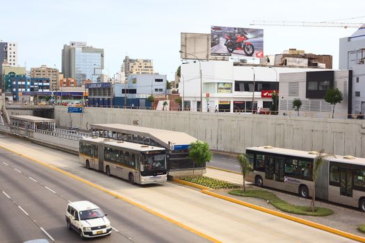 LIMA, PERU - FEBRUARY 13, 2012: Metropolitano bus of the Line A stopping at the crossing of the Avenues Ricardo Palma and Paseo de la Republica in Miraflores on February 13, 2012 in Lima, Peru. The Metropolitano is a Bus rapid transit system operating since 2010 in Lima running from North to South.