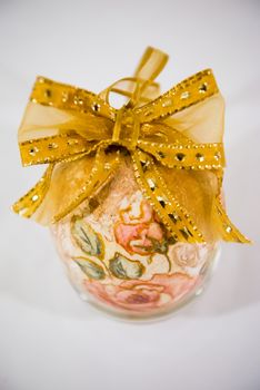 Easter egg decorated with flowers made by decoupage technique on light background