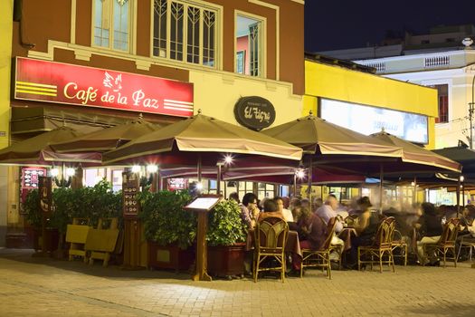 LIMA, PERU - MARCH 5, 2012: Unidentified people at the restaurants Cafe de la Paz, El Tigre and El Parquetito at Kennedy Park in Miraflores in the evening on March 5, 2012 in Lima, Peru. Miraflores is a touristy district of Lima with many restaurants, shops, and hostels. 