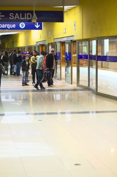 LIMA, PERU - JULY 21, 2013: Unidentified people waiting for the Metropolitano bus at the central bus station on July 21, 2013 in Lima, Peru.  The Metropolitano is a Bus rapid transit sytem operating since 2010 in Lima running from North to South.