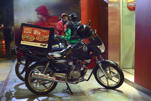 LIMA, PERU - MARCH 12, 2012: Motorbikes standing in front of PHD (Pizza Hut Delivery) on Jose Larco Avenue in Miraflores waiting to deliver on March 12, 2012 in Lima, Peru.