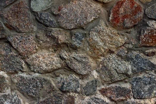 rocky wall whose stones of different colors and different shapes