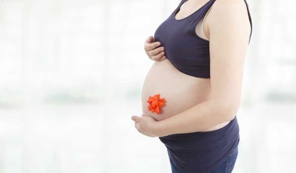 Closeup of pregnant woman at white background