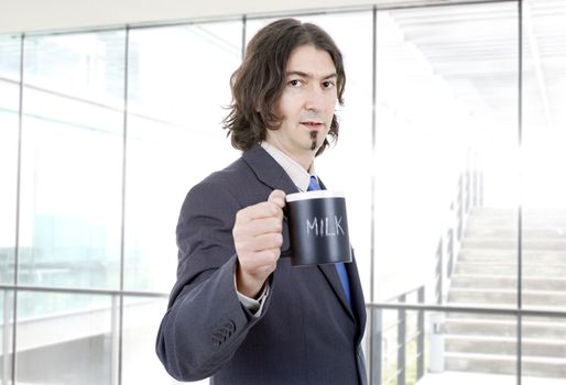 young business man with a cup of milk at the office