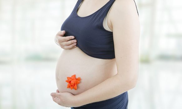 Closeup of pregnant woman at white background