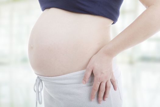 Closeup of pregnant woman at white background