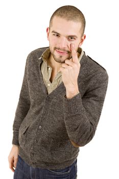 young casual man pointing to his eye, isolated on white