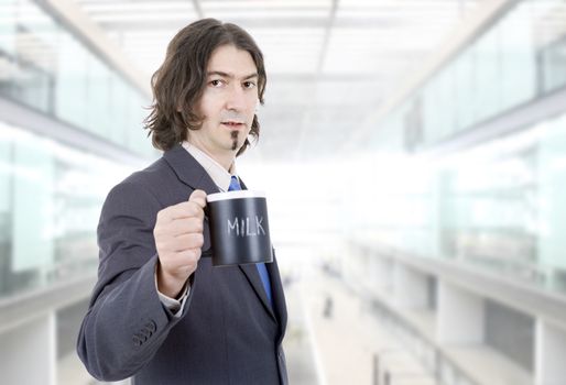 young business man with a cup of milk at the office