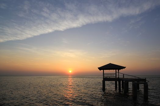  Silhouette of old pavilion in the sea at sunset