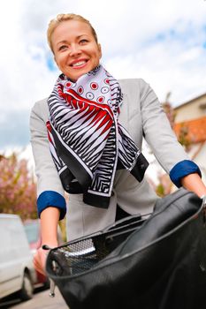 Business woman riding bicycle to work. Environmentally friendly and healthy way of urban transportation.