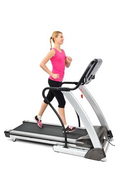 young woman doing exercises on treadmill, isolated, motion blur on moving parts