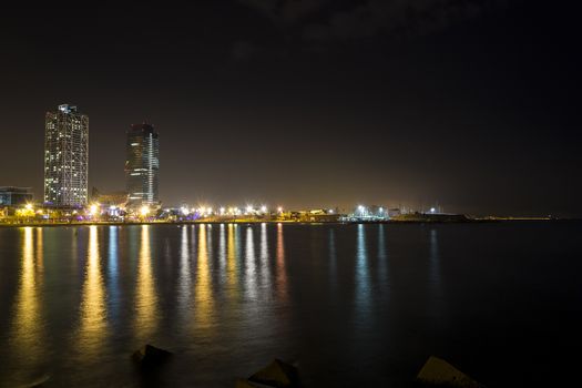 View of the promenade of Barcelona by night from the sea